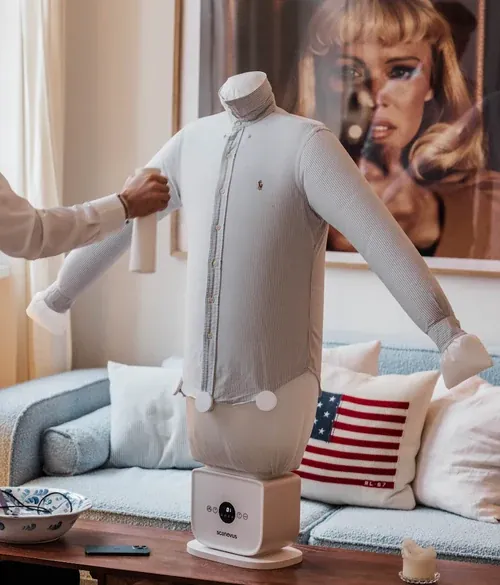 Spraying a shirt with a fine water mist before smoothing out creases